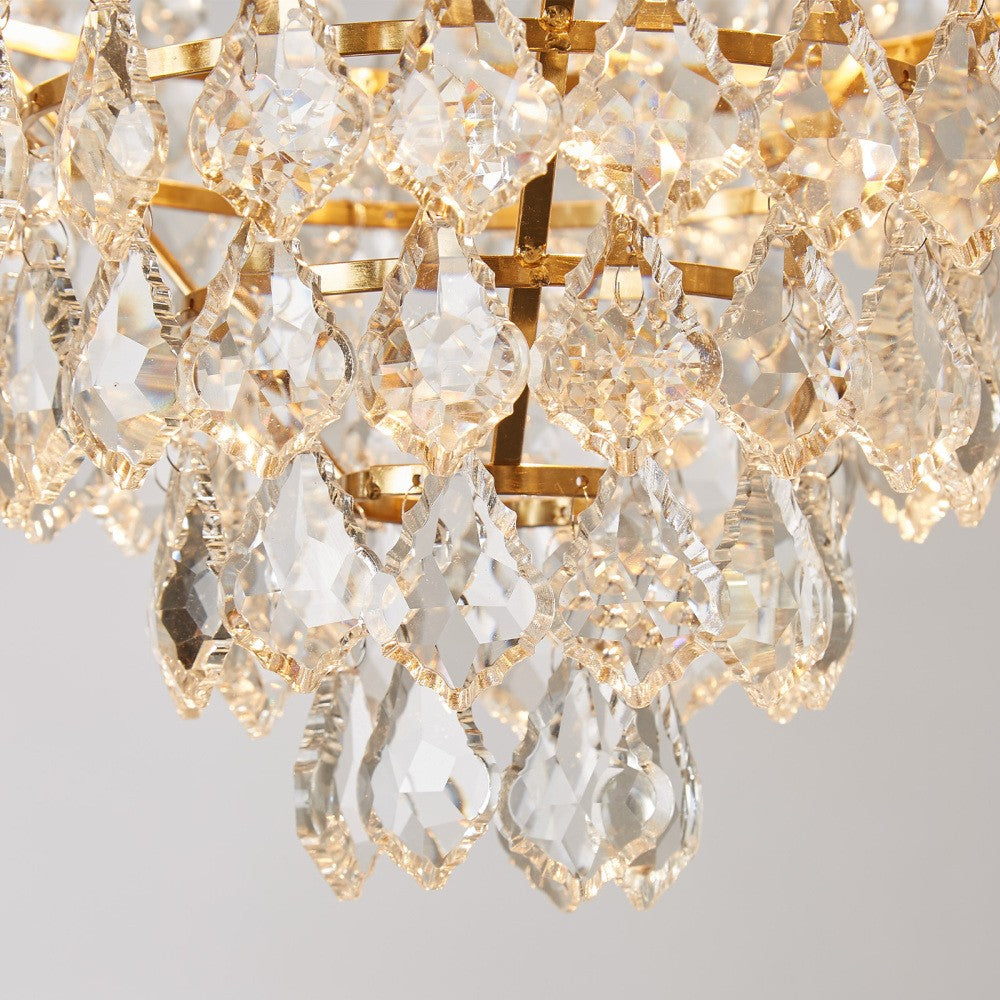 Luxurious gold crystal chandelier with intricate glass pendants reflecting warm light, elegant and eye-catching.