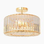 Gold round-frame chandelier with vertical clear glass panels, flush-mount design, sparkling modern elegance.