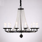 Black metal chandelier with eight candle bulbs and draped K9 crystal beads, modern elegance.