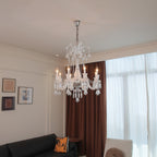 Maison Ornate Crystal Chandelier with 6 transparent arms and glowing bulbs, elegant modern lighting fixture.