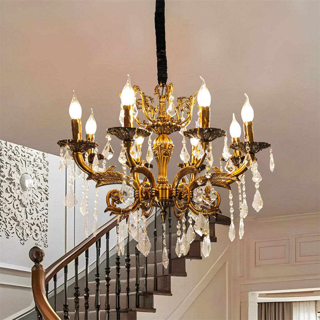 Maison Ornate antique brass chandelier with 12 arms, candle bulbs, and crystal accents.