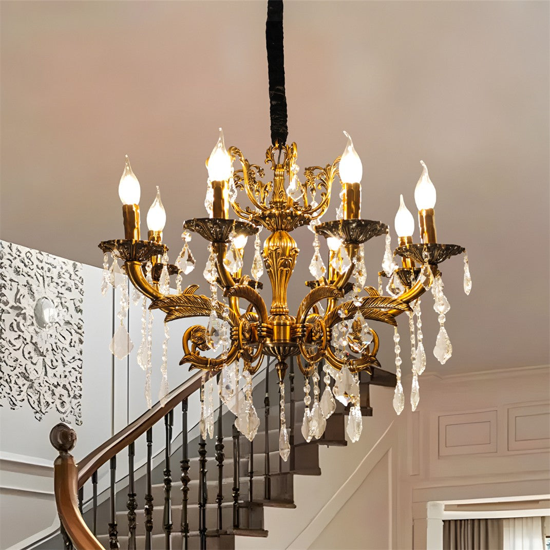 Maison Ornate antique brass chandelier with 12 arms, candle bulbs, and crystal accents.