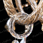 Twisted gold-toned glass rod interlocks with clear faceted ring on K9 Crystal chandelier.