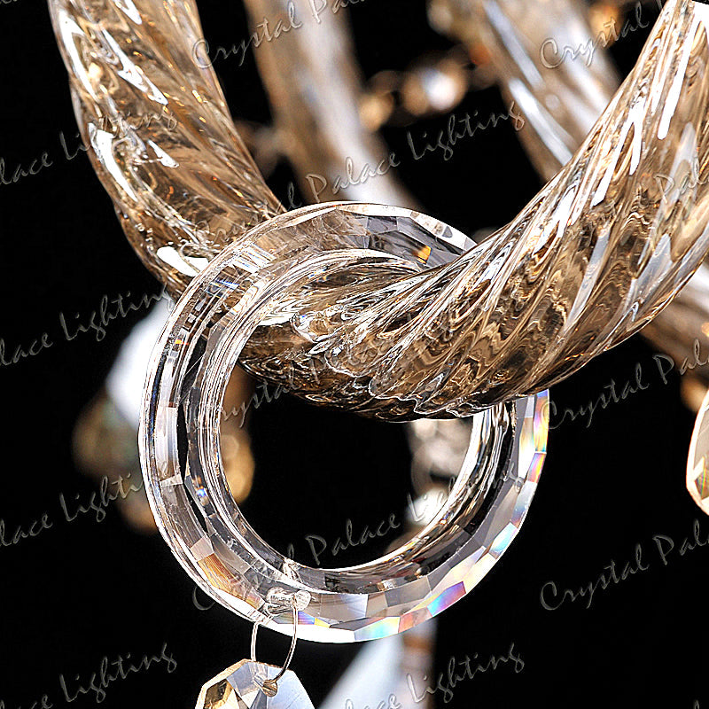 Twisted gold-toned glass rod interlocks with clear faceted ring on K9 Crystal chandelier.