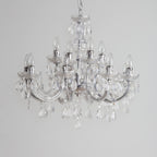 Maison Ornate Art Deco crystal chandelier with chrome arms, candle bulbs, and hanging droplets.