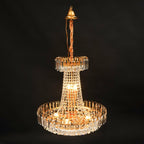 Empire Style Gold Tassel Crystal Chandelier by Maison Ornate with sparkling prisms and warm lights.