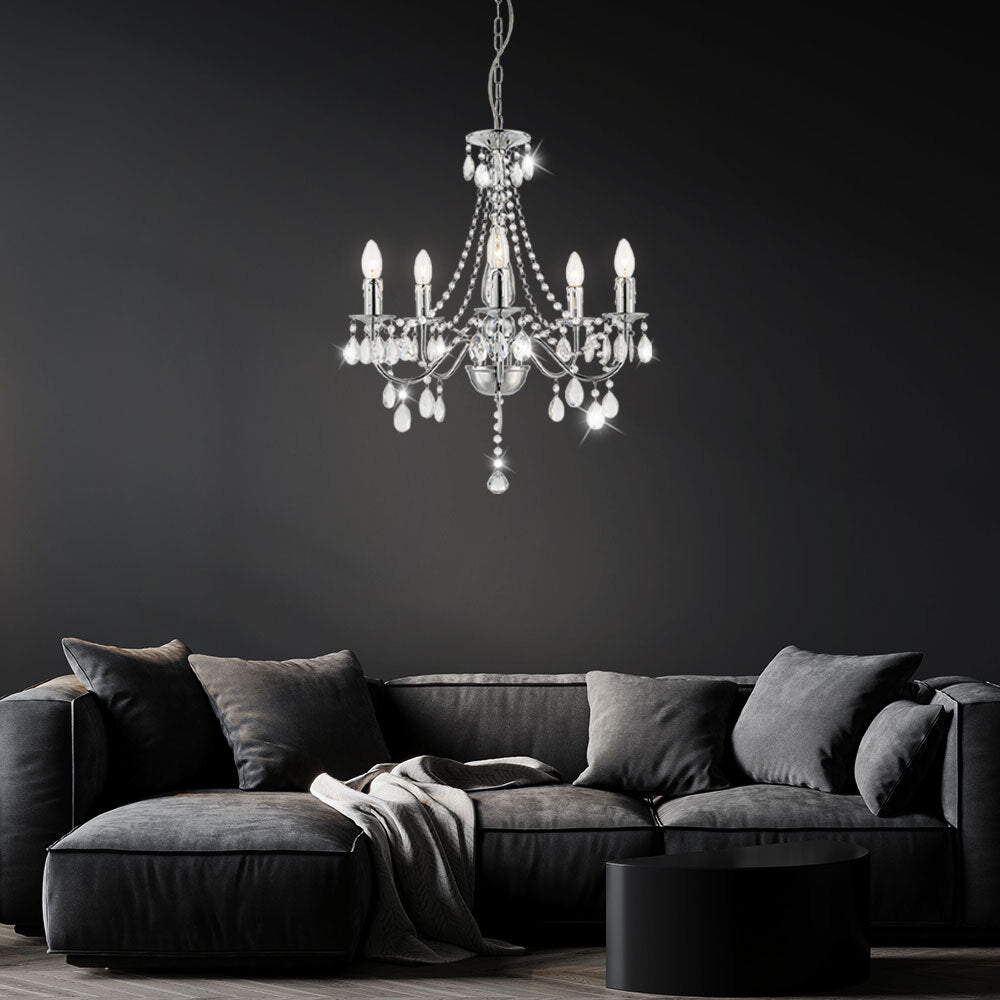 Elegant 5-branch crystal chrome chandelier by Maison Ornate with illuminated bulbs, modern and refined design.