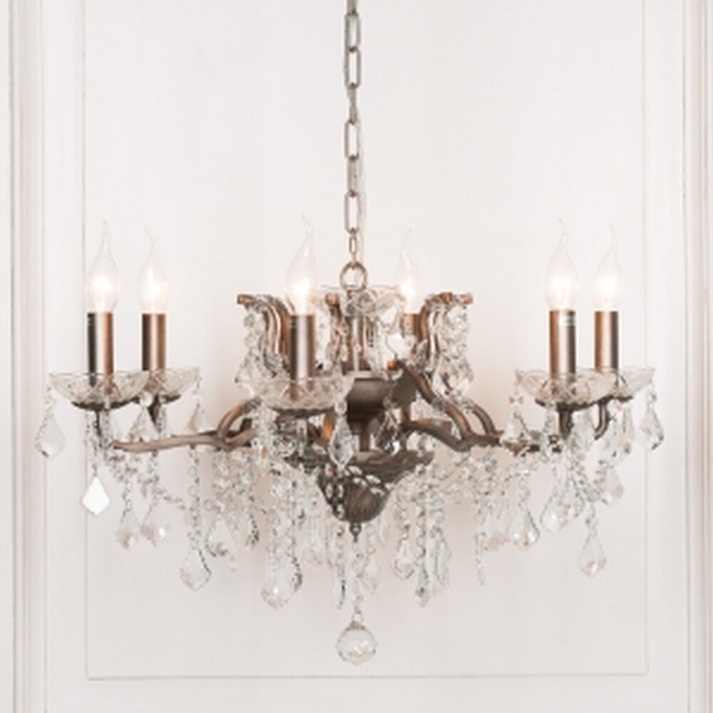 Maison Ornate French crystal chandelier with six silver arms, candle bulbs, ornate metalwork, hanging glass crystals.