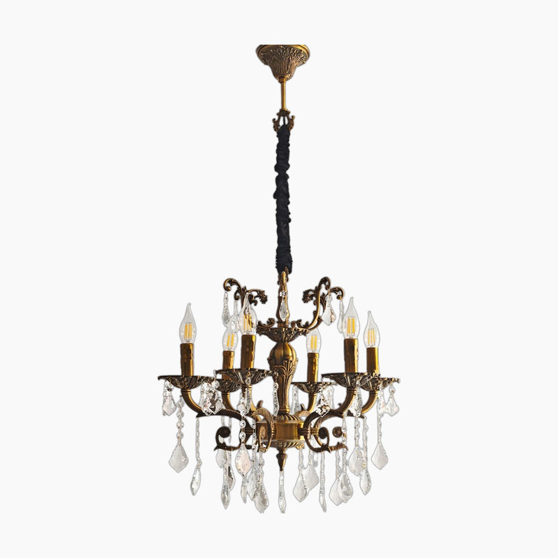 Ornate antique brass chandelier with 12 arms, intricate detailing, and clear crystal pendants.