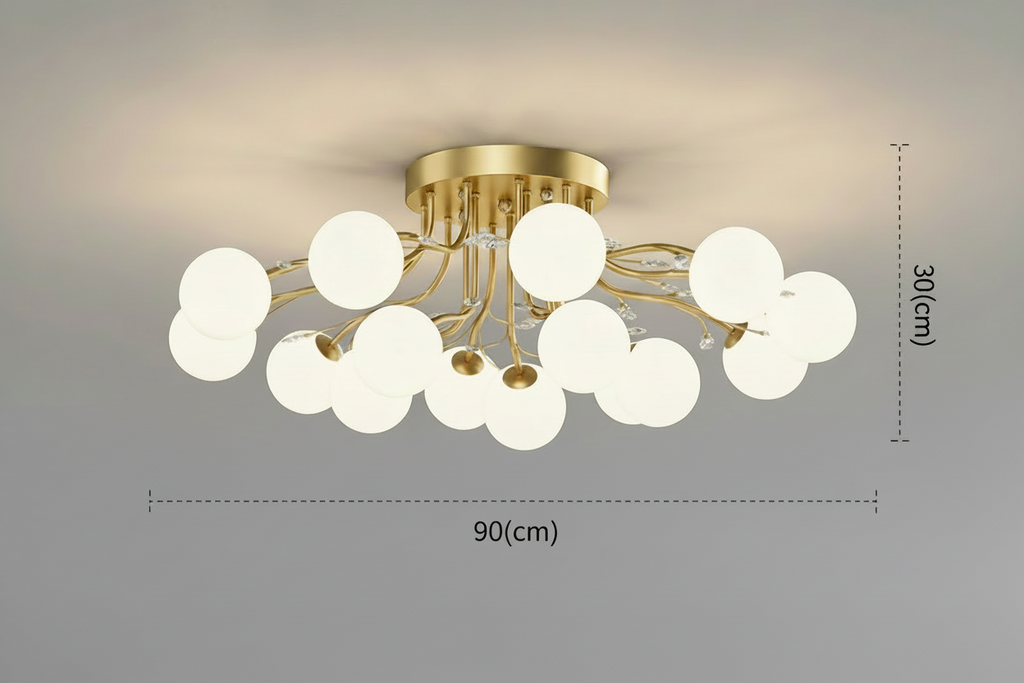 Modern gold chandelier with LED stars, clear glass, white globes in a branching design.