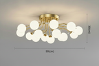 Modern gold chandelier with LED stars, clear glass, white globes in a branching design.