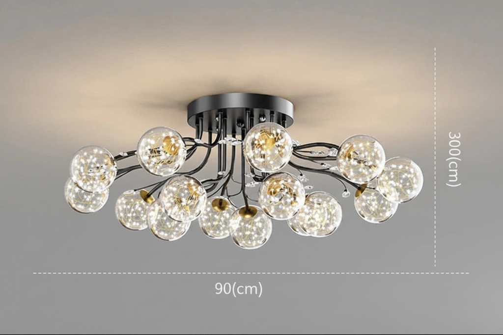 Modern black metal chandelier with clear glass LED crystal globes, warm-lit and star-accented. 90 cm wide, 30 cm high.